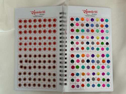 Sanskritt color swatch book with red and multicolor dots on a white background
